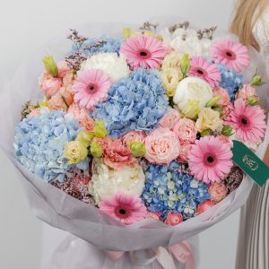 A large, beautiful bouquet of pink, blue, and white fresh flowers in a candy-like mix.
