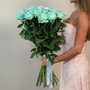 A close-up detail shot of the Tiffani blue rose petals, highlighting their rich sky blue color and soft, velvety texture.