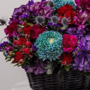 A close-up view of the luxury "Midnight Bloom" basket, highlighting the deep tones and fresh flower appeal.
