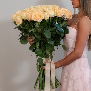 A close-up side view of the Peach Avalanche roses, showcasing their soft, delicate petals and long stems.