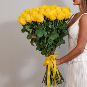 A close-up side view of the Yellow Armine roses, showcasing their vibrant petals and long stems.