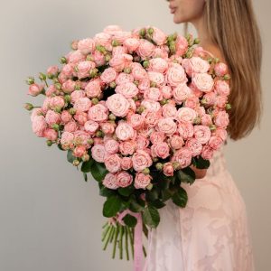 A stunning, full bunch of fresh, long-stemmed Madam Bombastic pink spray roses, arranged against a clean background.