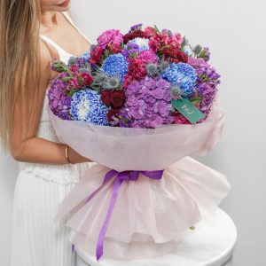 A stunning bouquet of dark purple, burgundy, and deep red flowers.