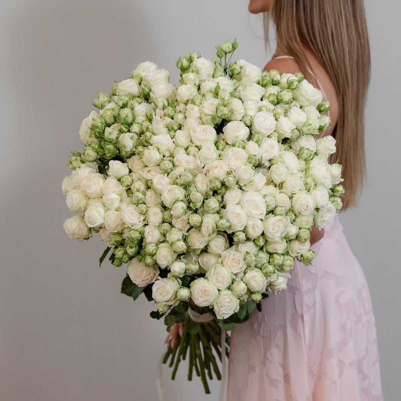 A stunning, full bunch of fresh, long-stemmed Miss Bombastic white spray roses, arranged against a clean background.
