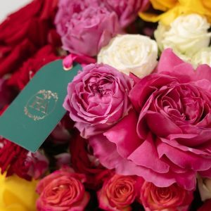 A close-up view of the Vibrant rose box, showing the beautiful variety of pink, red, and yellow roses.