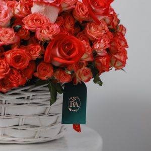 A full view of the luxury Flame basket, highlighting the mix of red, orange, and pink roses.