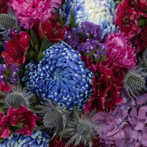 A top-down view of the dark-colored Midnight Bloom bouquet, highlighting its rich textures and tones.