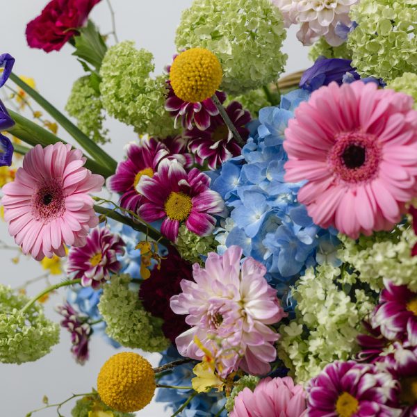 A full view of the Joyful flower basket, showcasing its playful design and vibrant color palette.