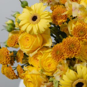 A full view of the Yellow Classic Beauty basket, highlighting the mix of various yellow flowers and the woven basket.