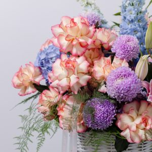 A close-up view of the luxury Eden Charm basket, showing the detail of the various lilies and other blooms.