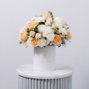 A beautiful arrangement of fresh pastel flowers in a classic floral box.