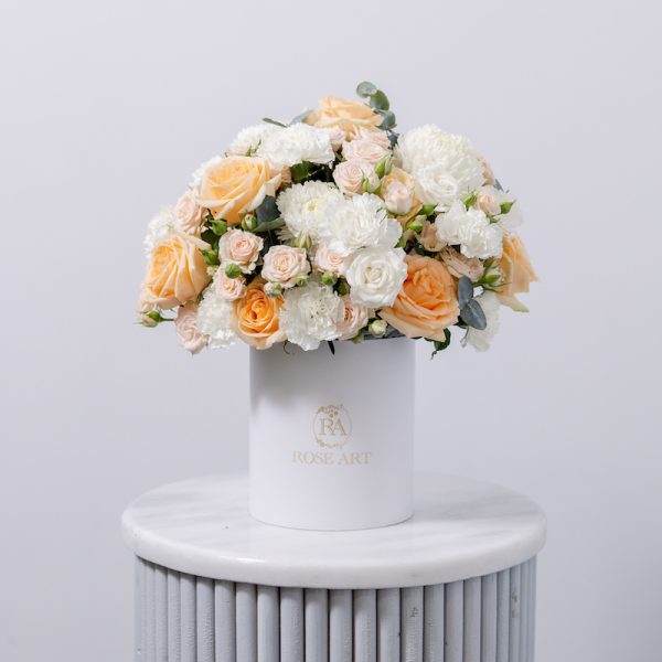 A beautiful arrangement of fresh pastel flowers in a classic floral box.