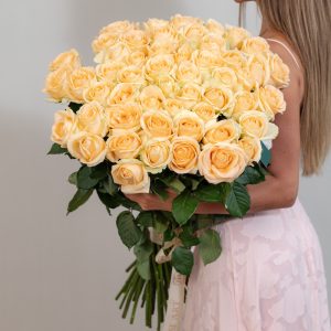 A stunning bunch of fresh, long-stemmed peach Avalanche roses on a white background.