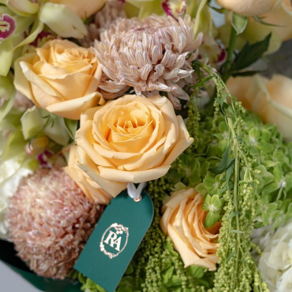 A close-up side view of the Earthy bouquet, showing the detail of the orchids and amaranthus accents.