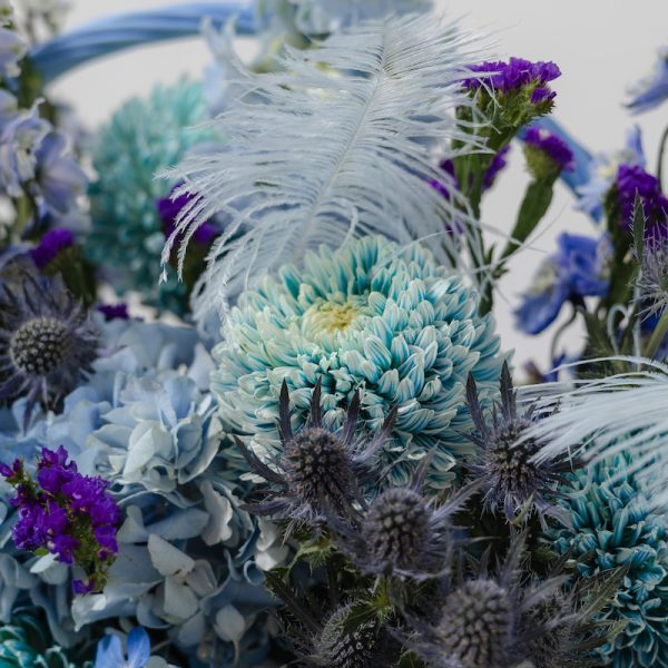 A full view of the Art of Blue flower basket, showcasing its modern design and shades of blue blooms.