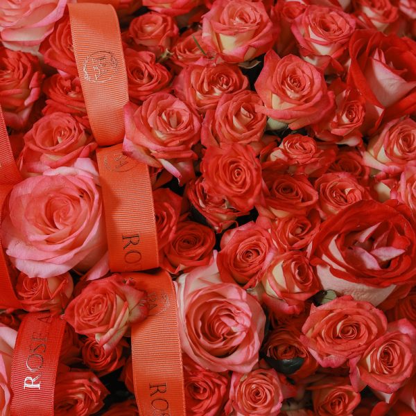 A close-up side view of the Flame basket, showing the detail of the orange spray roses.