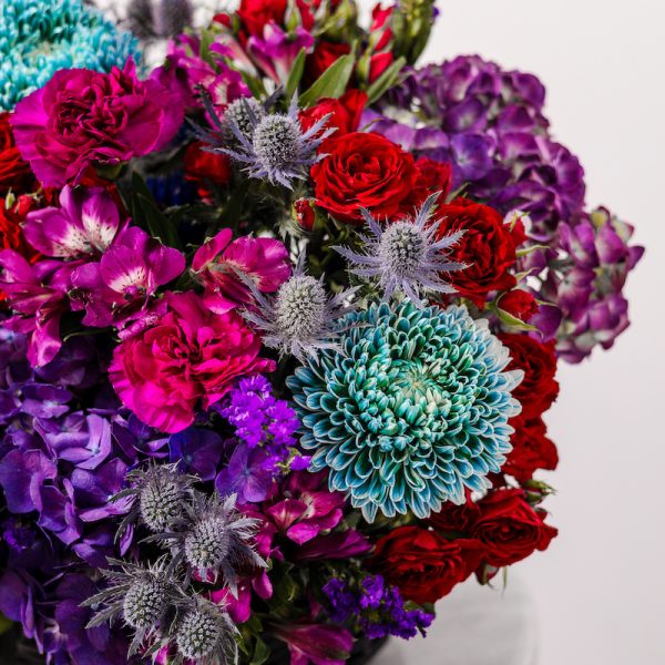 A top-down view of the Midnight Bloom basket arrangement, showing the full composition and dark color palette.