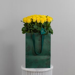 A large bunch of Penny Lane roses beautifully presented in a stylish, modern vase.