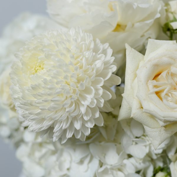 A side view of the Art of White floral basket, showing the details of the peonies and amaranthus accents.