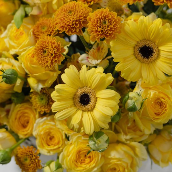 A close-up side view of the Yellow Classic Beauty basket, showing the detail of the flowers in the woven basket.